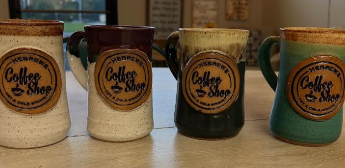 Four glazed Hebrews pottery mugs in different colors